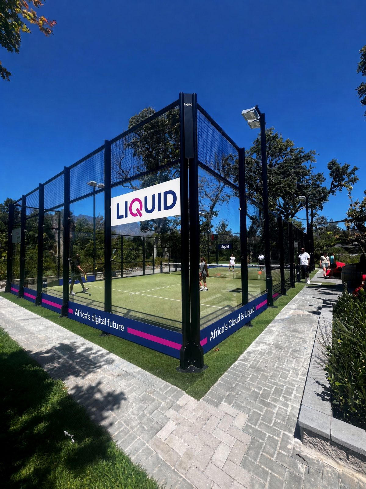Outdoor padel court with a sponsor board on the glass